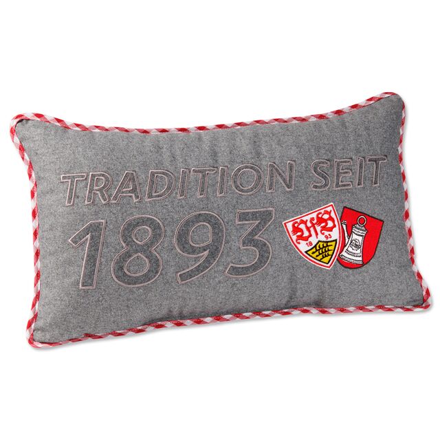 graues Kissen mit rot-weißem Rand und der Aufschrift Tradition seit 1893