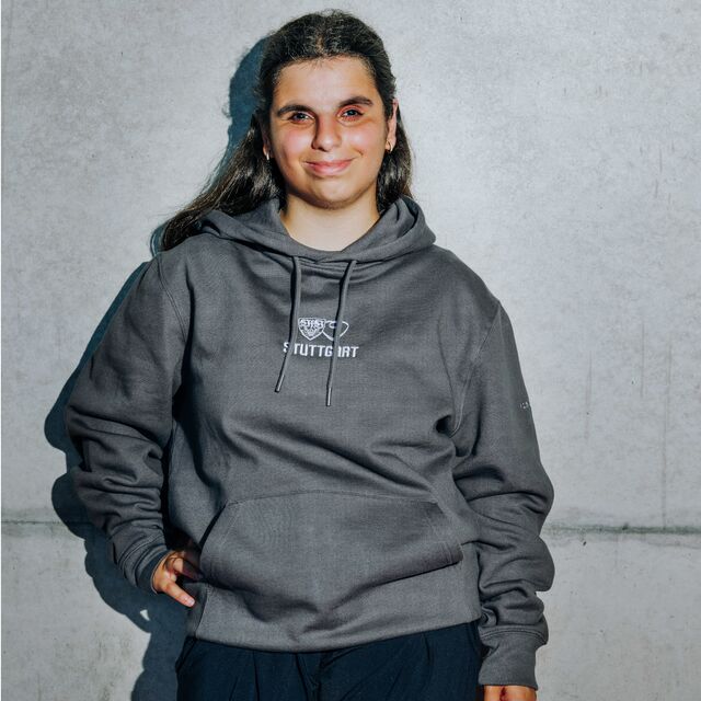 weibliches Model trägt den VfB Hoodie Stuttgart Brailleschrift